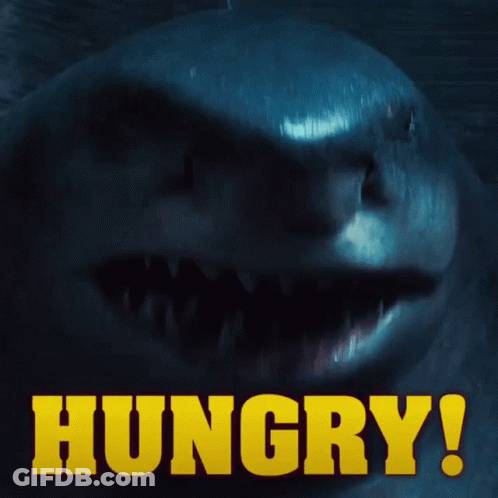 A Close Up Of A Shark With The Words Hungry In Yellow GIF