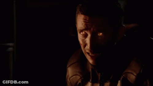 A Close Up Of A Skull With Flames Coming Out Of It 'S Head GIF
