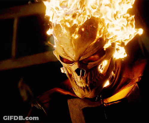 A Close Up Of A Skull With Flames Coming Out Of It 'S Head GIF