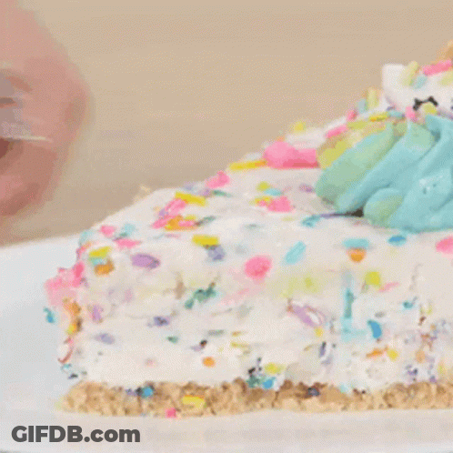 A Close Up Of A Slice Of Cake With Sprinkles On Top GIF