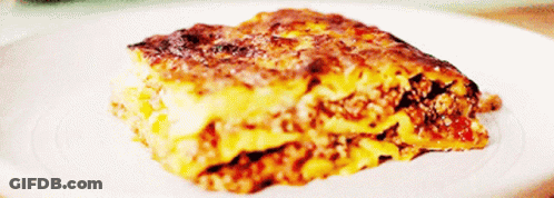 A Close Up Of A Slice Of Lasagna On A Plate GIF
