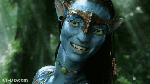 A Close Up Of A Smiling Avatar With Blue Skin GIF