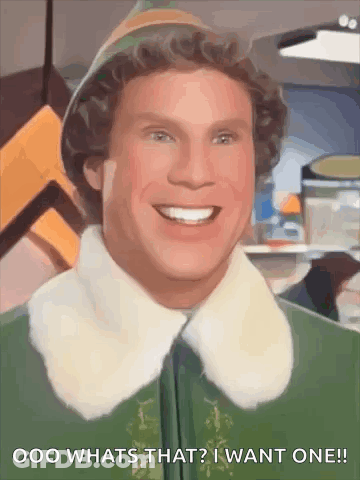 A Close Up Of A Smiling Elf With The Words `` What 'S That ? I Want One '' Written Below Him . GIF