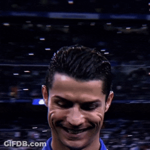 A Close Up Of A Soccer Player 'S Face With A Crowd Behind Him GIF