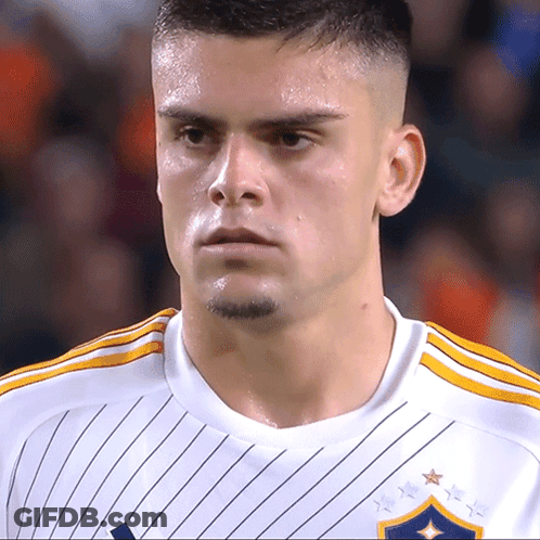 A Close Up Of A Soccer Player Wearing A White Shirt GIF