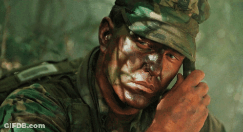 A Close Up Of A Soldier 'S Face With A Camouflage Uniform GIF