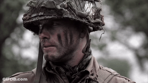 A Close Up Of A Soldier 'S Face With A Helmet On His Head GIF