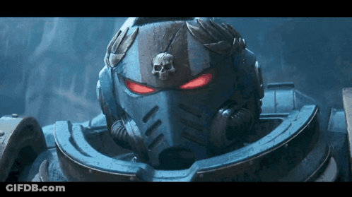 A Close Up Of A Space Marine 'S Helmet With Red Eyes And A Skull On It GIF