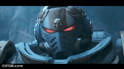 A Close Up Of A Space Marine 'S Helmet With Red Eyes GIF