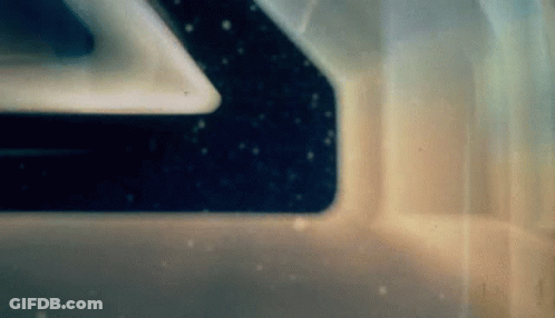 A Close Up Of A Space Ship 'S Window With A Reflection Of The Stars In It . GIF