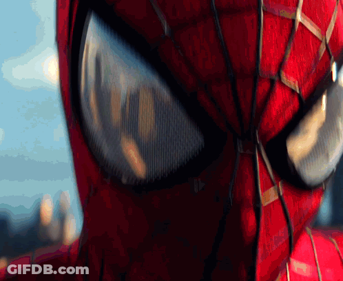 A Close Up Of A Spider Man 'S Eyes With A City In The Background GIF