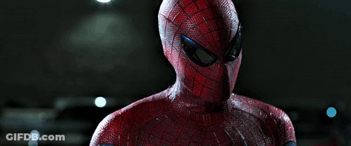 A Close Up Of A Spider Man 'S Face Against A Dark Background GIF
