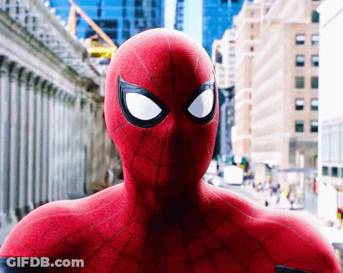 A Close Up Of A Spider Man 'S Face In A City GIF
