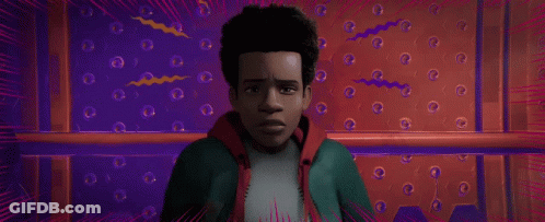 A Close Up Of A Spider Man 'S Face In A Red And Blue Room . GIF