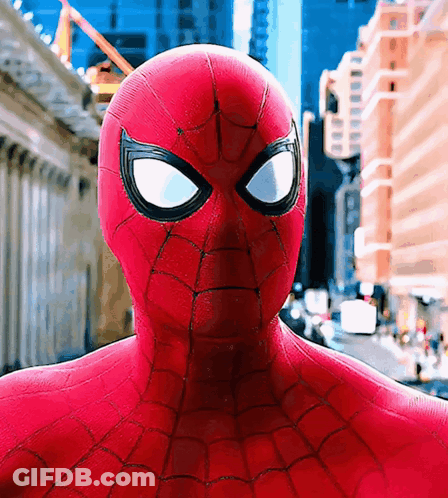 A Close Up Of A Spider Man 'S Face In Front Of A City GIF