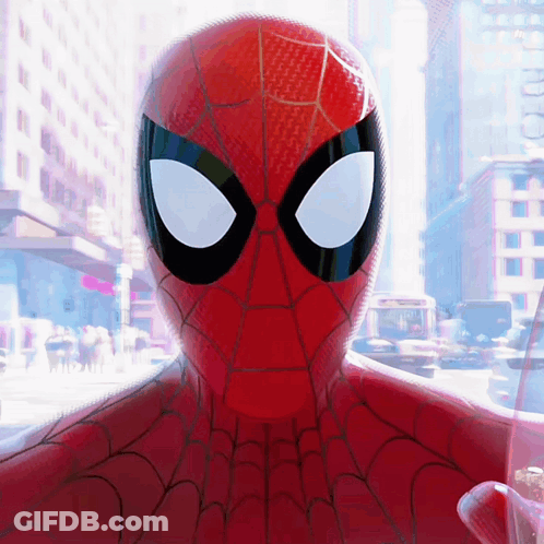 A Close Up Of A Spider Man 'S Face With A City Background GIF