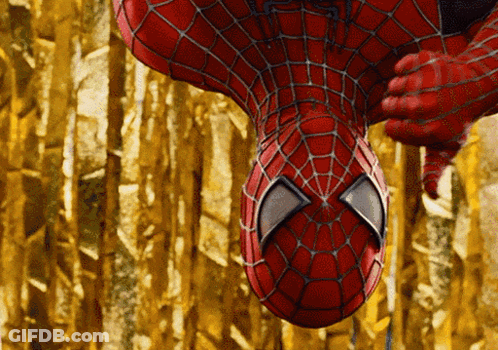A Close Up Of A Spider Man 'S Face With A Gold Background GIF