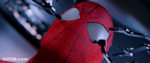 A Close Up Of A Spider Man 'S Face With A Hole In It GIF