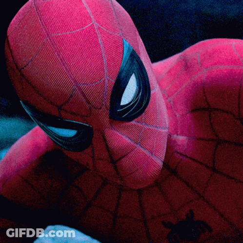 A Close Up Of A Spider Man 'S Face With A Spider On His Chest GIF