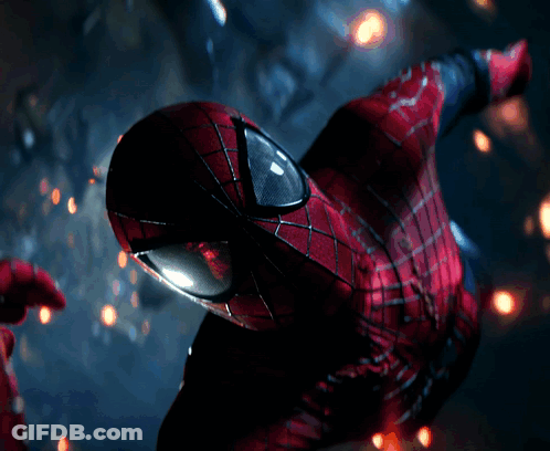 A Close Up Of A Spider Man 'S Face With Glowing Eyes GIF