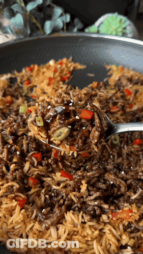 A Close Up Of A Spoon In A Pan Of Food GIF
