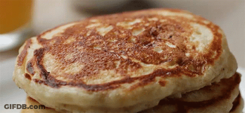 A Close Up Of A Stack Of Pancakes On A Table GIF