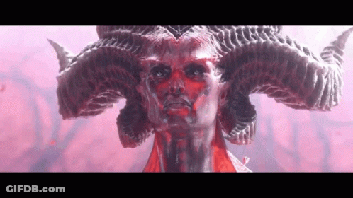 A Close Up Of A Statue Of A Demon With Horns On His Head . GIF