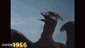 A Close Up Of A Statue Of A Dragon With Its Mouth Open . GIF