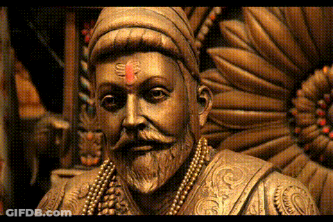 A Close Up Of A Statue Of A Man With A Beard And A Red Bindi On His Forehead GIF