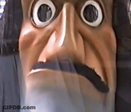 A Close Up Of A Statue Of A Man With A Beard And Big Eyes . GIF