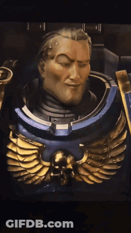 A Close Up Of A Statue Of A Man With A Skull And Wings On His Chest GIF