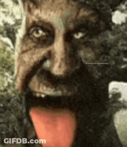 A Close Up Of A Statue Of A Man With His Tongue Out . GIF