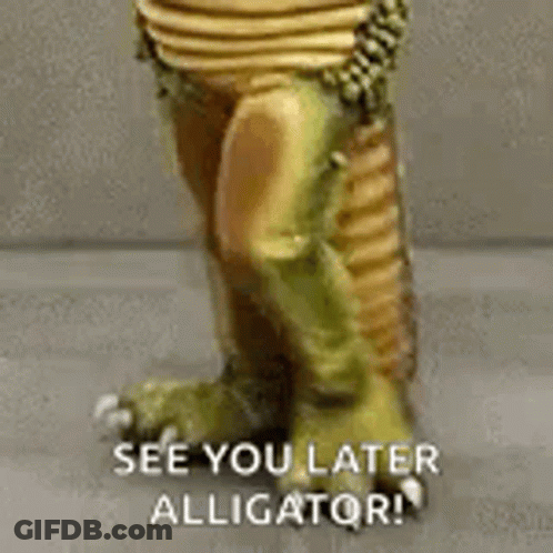 A Close Up Of A Statue Of An Alligator With The Words `` See You Later Alligator '' Written On It . GIF