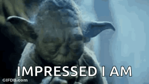 A Close Up Of A Statue Of Yoda Saying Impressed I Am GIF