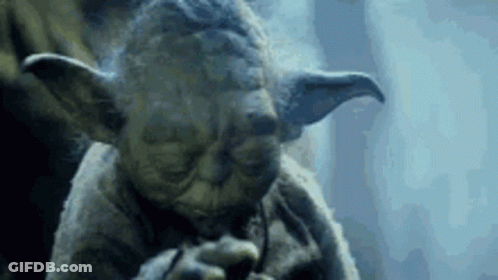 A Close Up Of A Statue Of Yoda Smoking A Pipe In A Dark Room . GIF