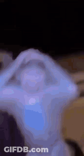 A Close Up Of A Statue With A Blue Light Coming Out Of It 'S Eyes . GIF