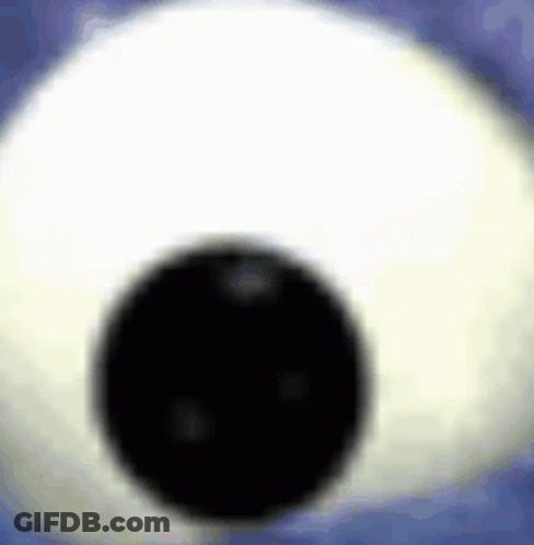 A Close Up Of A Stuffed Animal Eye With A Black Pupil . GIF