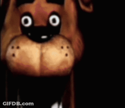 A Close Up Of A Stuffed Animal 'S Face With Big Eyes . GIF