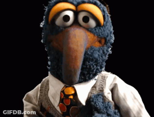 A Close Up Of A Stuffed Animal Wearing A Tie GIF
