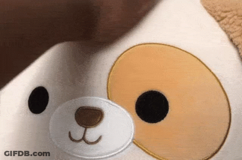 A Close Up Of A Stuffed Animal With A Dog Face On It GIF