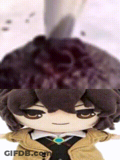 Close Up Of Stuffed Animal With Brown Hair And Hat GIF