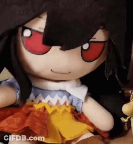 A Close Up Of A Stuffed Doll With Red Eyes . GIF