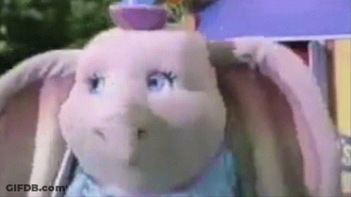 A Close Up Of A Stuffed Elephant With A Hat On GIF