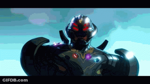 A Close Up Of A Superhero With Red Eyes And Purple Gems On His Chest GIF