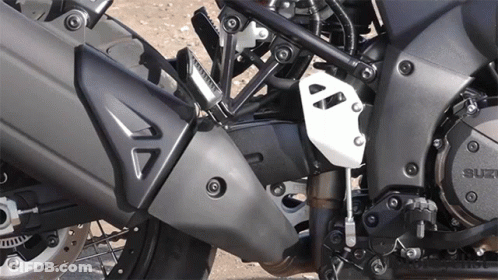 A Close Up Of A Suzuki Motorcycle Engine And Exhaust GIF