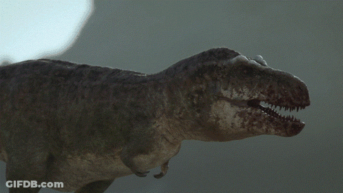 A Close Up Of A T-Rex Dinosaur With Its Mouth Open GIF