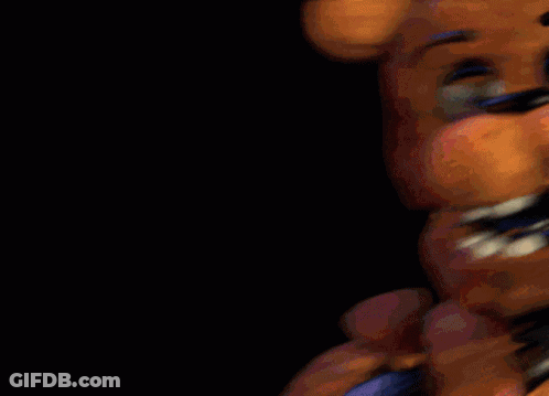A Close Up Of A Teddy Bear 'S Face With A Black Background GIF