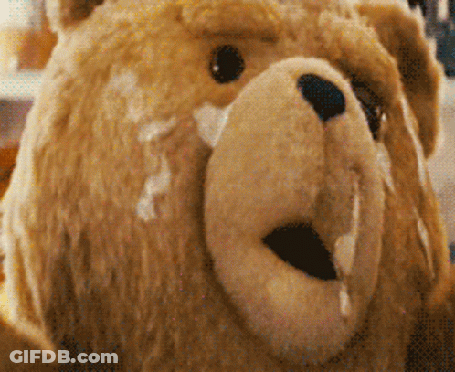 A Close Up Of A Teddy Bear 'S Face With Milk Dripping Out Of It 'S Mouth GIF