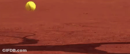 A Close Up Of A Tennis Racket Hitting A Tennis Ball On A Tennis Court . GIF