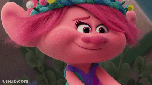 A Close Up Of A Troll With Pink Hair And Purple Eyes GIF